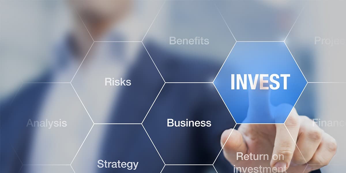 Investment planning desk with charts and paperwork